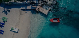 Albania beach with boat and jetty