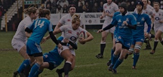 An England rugby player gets tackled in a Women’s Six Nations match.